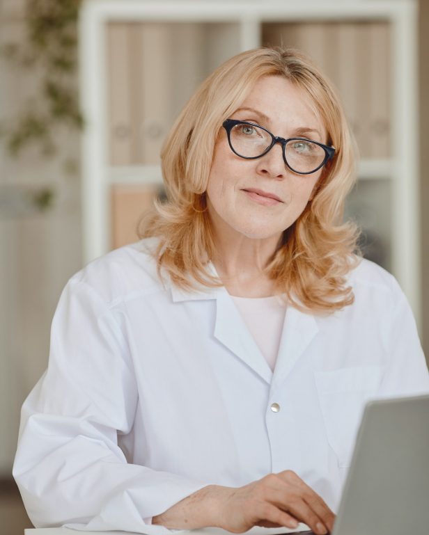 Mature Female Doctor Posing at Desk